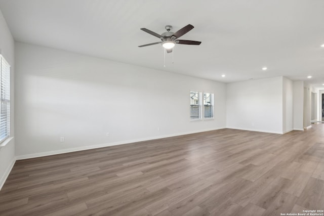 unfurnished room featuring ceiling fan and light wood-type flooring