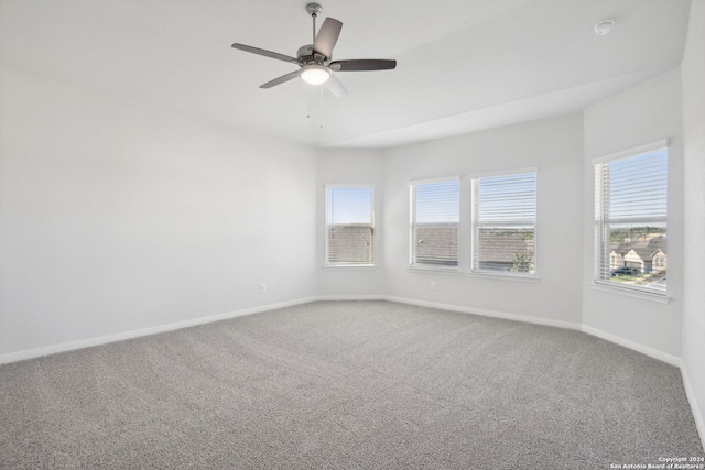 empty room with ceiling fan and carpet floors