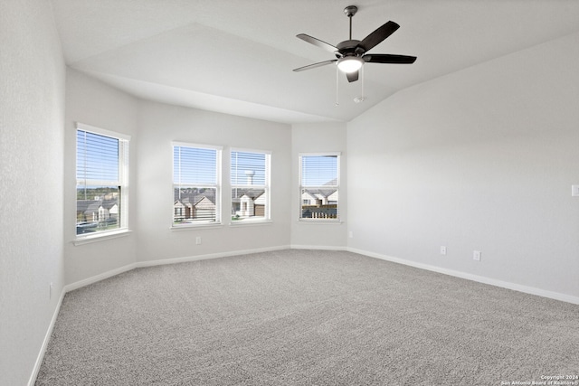 spare room with carpet floors, vaulted ceiling, and ceiling fan