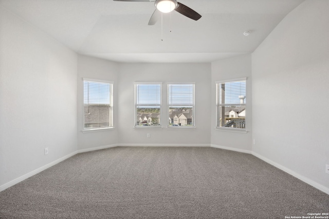 carpeted empty room with plenty of natural light and ceiling fan