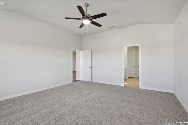 unfurnished bedroom with ceiling fan, ensuite bathroom, lofted ceiling, and light carpet