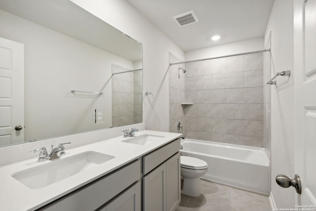 full bathroom featuring tile patterned flooring, vanity, toilet, and tiled shower / bath