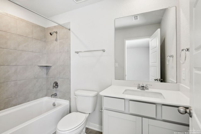 full bathroom with tiled shower / bath combo, toilet, and vanity