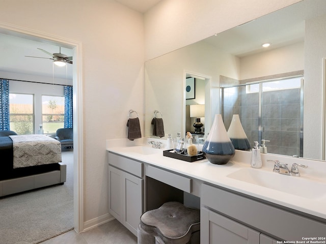 bathroom with ceiling fan, a shower with door, and vanity