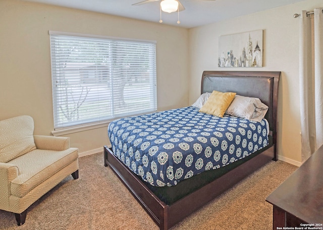 carpeted bedroom with multiple windows and ceiling fan