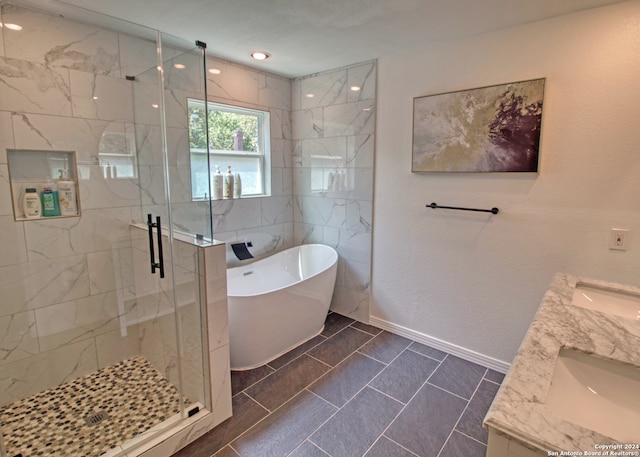 bathroom with vanity, tile patterned flooring, and plus walk in shower