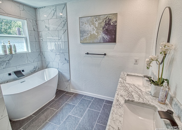 bathroom featuring vanity and a tub