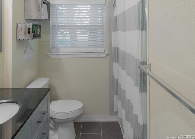 bathroom featuring vanity, a shower with curtain, toilet, and tile patterned flooring