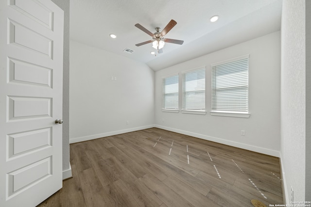 unfurnished room with ceiling fan, wood-type flooring, and vaulted ceiling