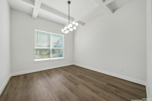 empty room featuring beam ceiling, coffered ceiling, an inviting chandelier, and hardwood / wood-style floors