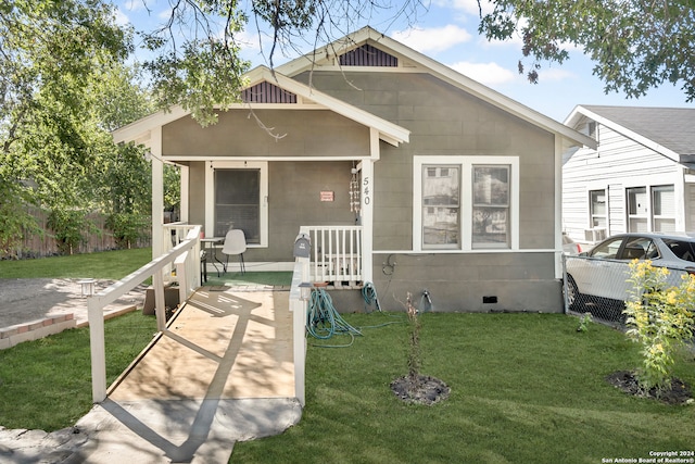 back of house featuring a yard and a porch