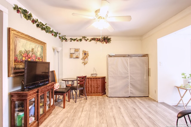 living area with light wood-type flooring and ceiling fan