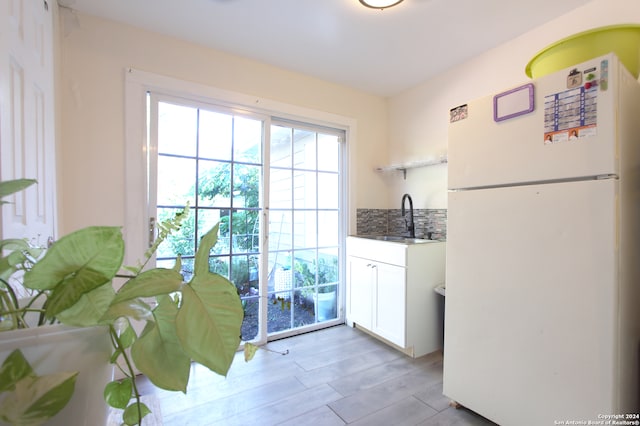 entryway with sink and light hardwood / wood-style flooring