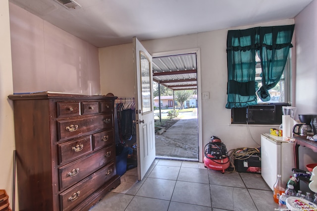 doorway to outside featuring cooling unit and light tile patterned floors