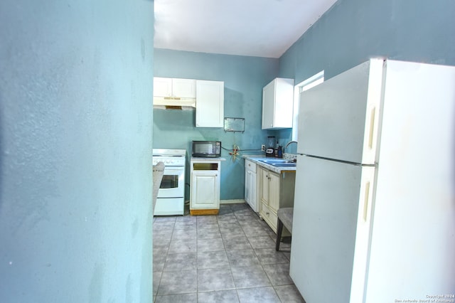 kitchen featuring white cabinetry, sink, light tile patterned floors, and white appliances