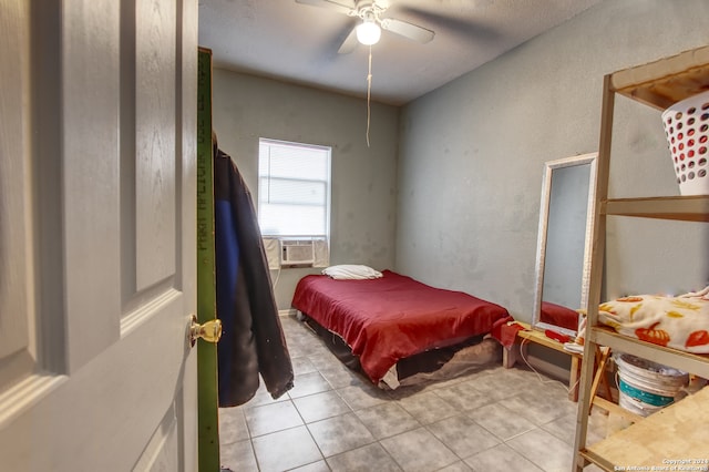 tiled bedroom featuring ceiling fan