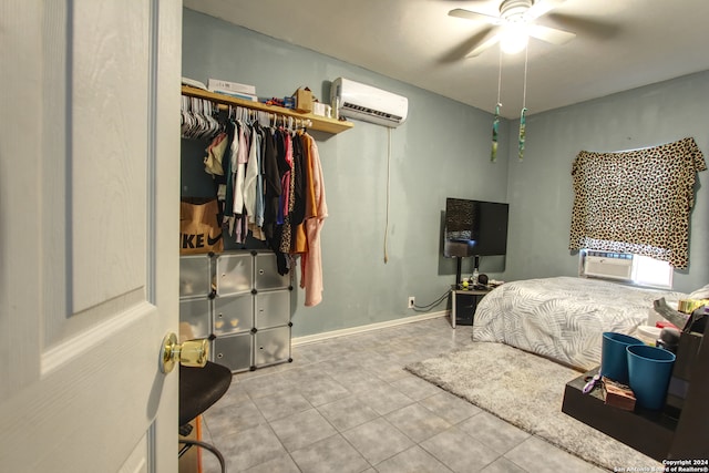 bedroom featuring cooling unit, a closet, ceiling fan, a wall unit AC, and light tile patterned floors