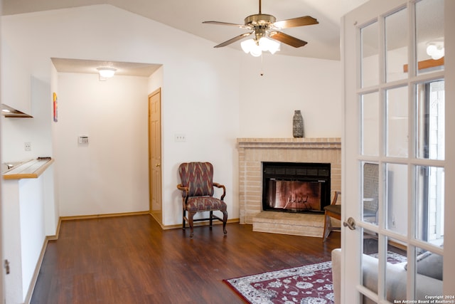 living area featuring ceiling fan, a fireplace, lofted ceiling, and dark hardwood / wood-style floors