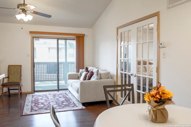 living room with dark hardwood / wood-style floors, ceiling fan, and vaulted ceiling