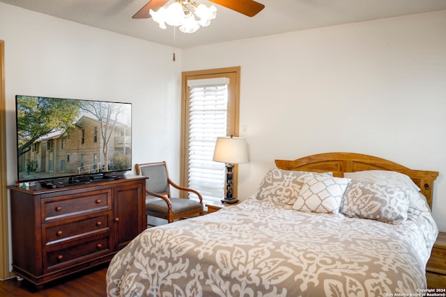 bedroom with ceiling fan and dark hardwood / wood-style floors