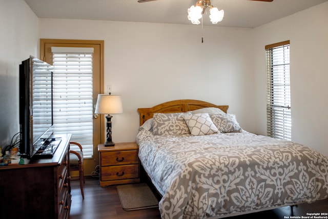 bedroom with ceiling fan and dark hardwood / wood-style floors