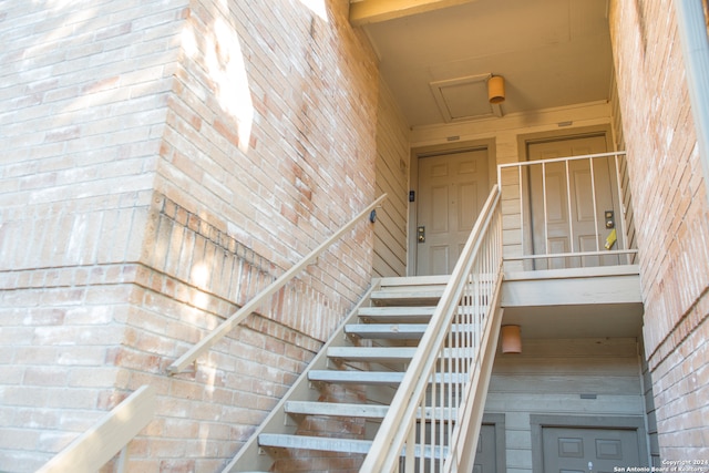 stairway featuring a towering ceiling