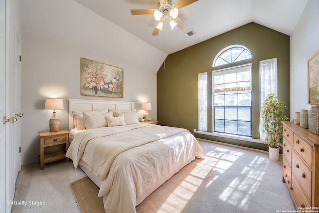 bedroom with ceiling fan, light carpet, and lofted ceiling