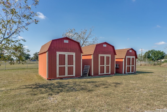 view of outbuilding with a yard