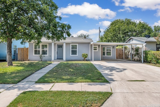 ranch-style house with a carport and a front lawn