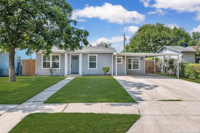 single story home with a front lawn and a carport