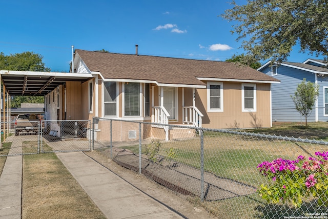 view of front of house featuring a front lawn and a carport