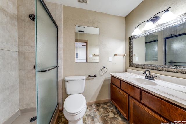 bathroom featuring vanity, toilet, and walk in shower