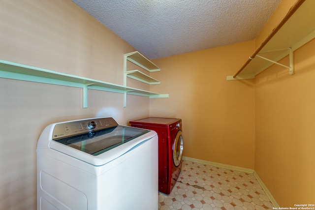 washroom featuring washer and dryer and a textured ceiling