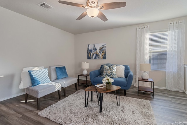 living room featuring ceiling fan and wood-type flooring