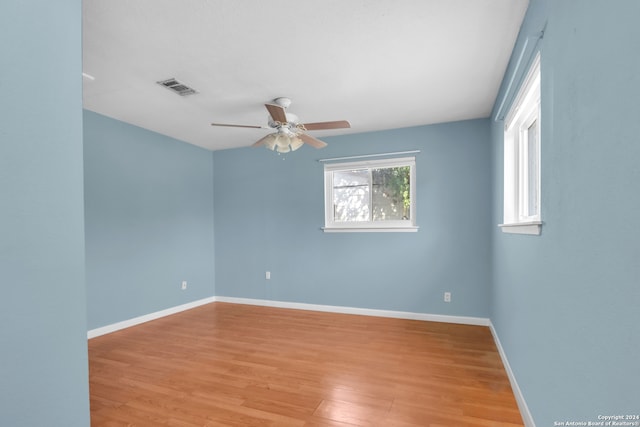 spare room with light hardwood / wood-style flooring and ceiling fan