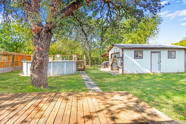 wooden deck featuring a yard and a fenced in pool