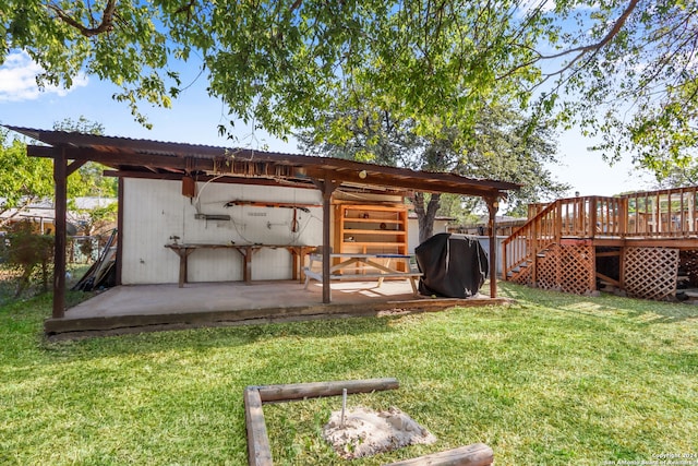 view of yard featuring a wooden deck and a patio area