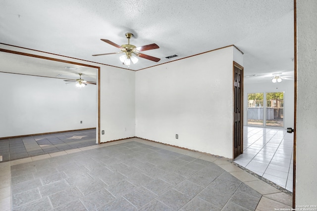 spare room with a textured ceiling