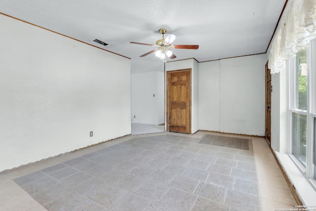 spare room with ceiling fan and a textured ceiling