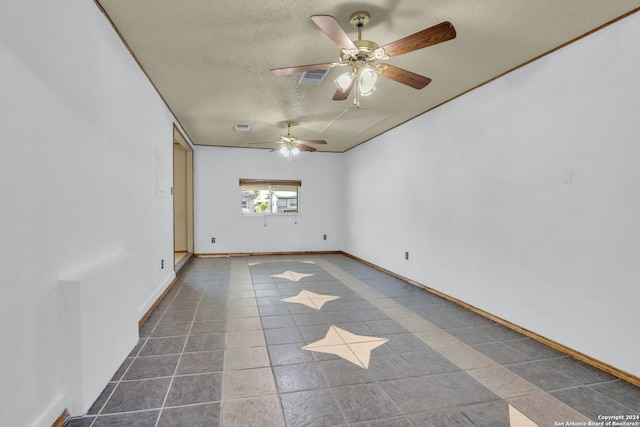 tiled spare room featuring a textured ceiling and ceiling fan