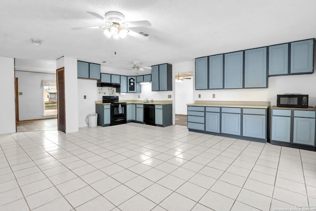 kitchen featuring blue cabinets, black appliances, and light tile patterned floors