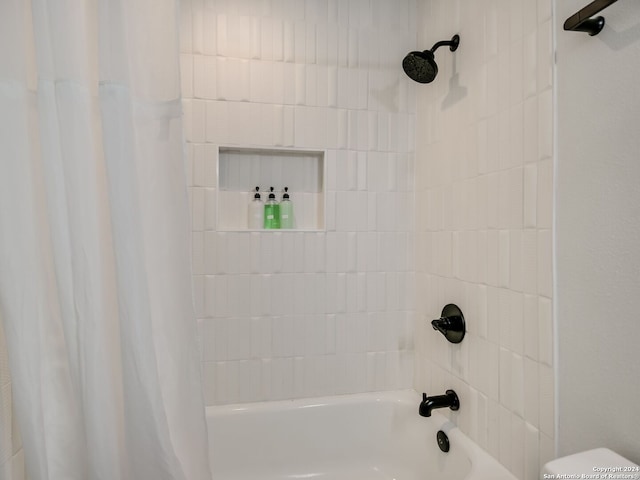 bathroom with shower / bath combination with curtain and toilet