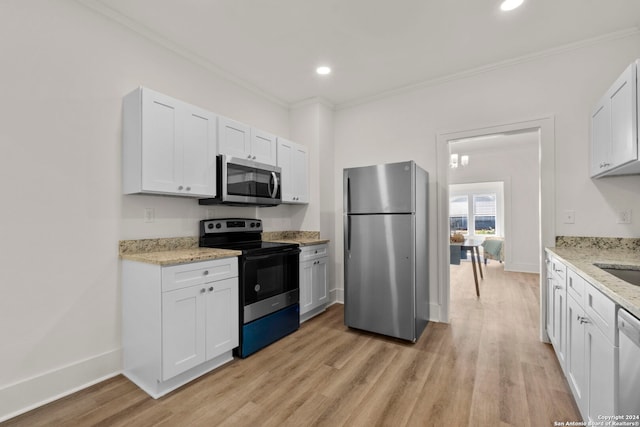 kitchen featuring ornamental molding, white cabinetry, stainless steel appliances, and light wood-type flooring