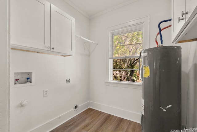 clothes washing area with electric water heater, wood-type flooring, hookup for an electric dryer, ornamental molding, and cabinets