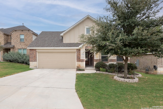 view of front of home featuring a front yard and a garage