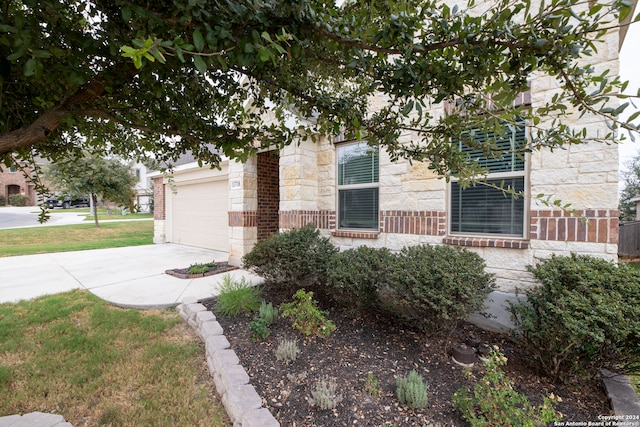 view of front of property with a front yard and a garage