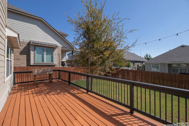 wooden terrace with a yard