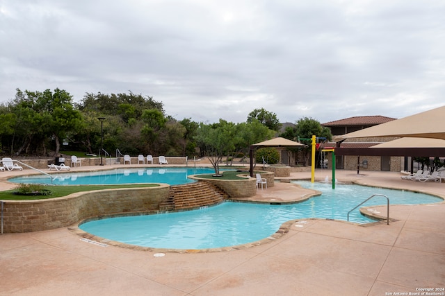 view of swimming pool with a gazebo, pool water feature, and a patio area