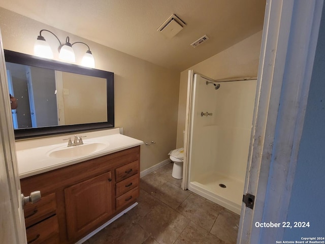 bathroom with lofted ceiling, visible vents, toilet, vanity, and walk in shower