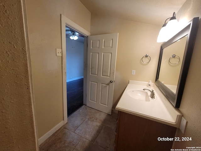 bathroom featuring vanity, ceiling fan, lofted ceiling, and tile patterned floors